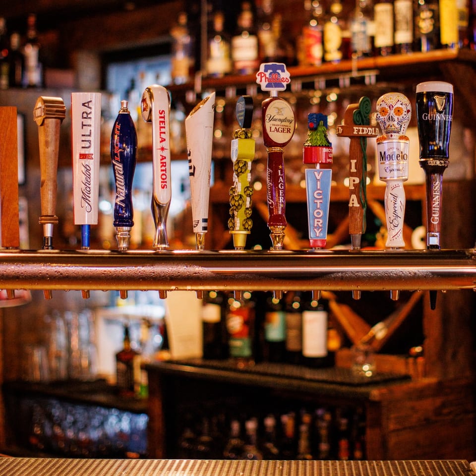 Draft taps and whiskey shelves at Saloon 151.