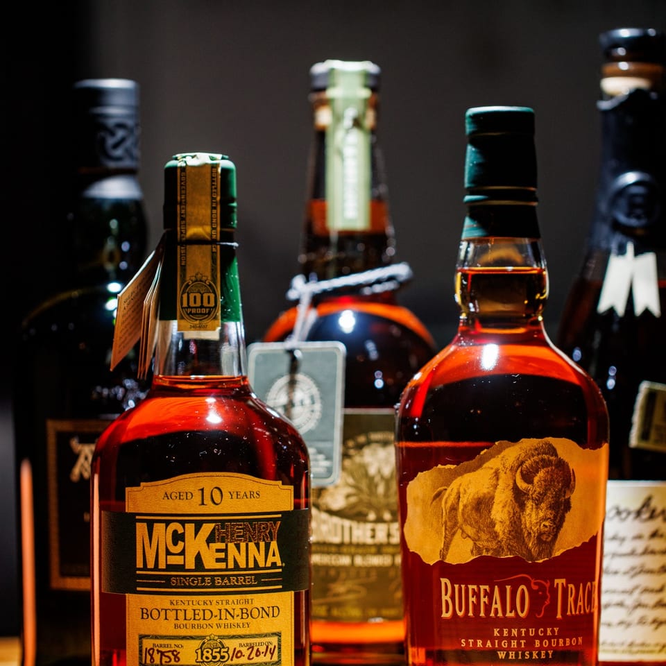 Henry McKenna and Buffalo Trace bourbon bottles.