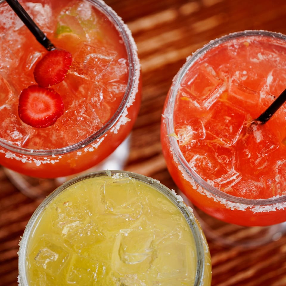 Colorful margaritas with salted rims.