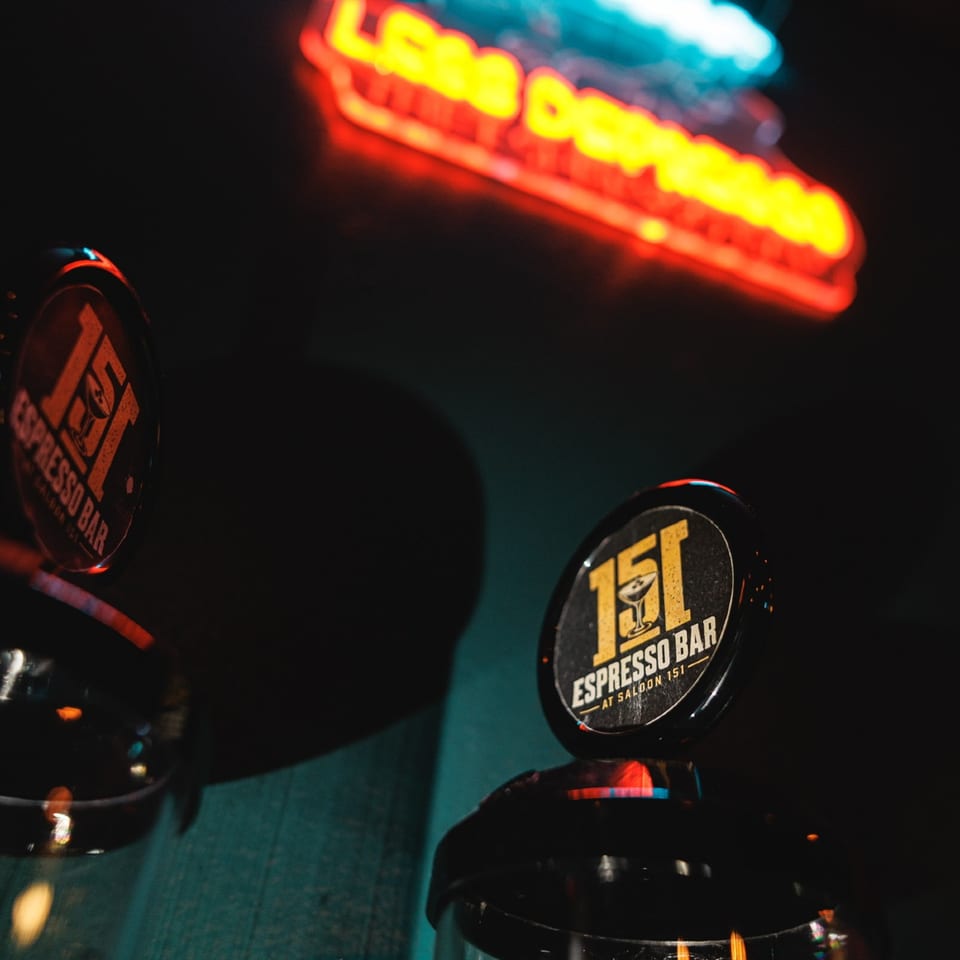 Espresso Bar taps and glowing neon sign.
