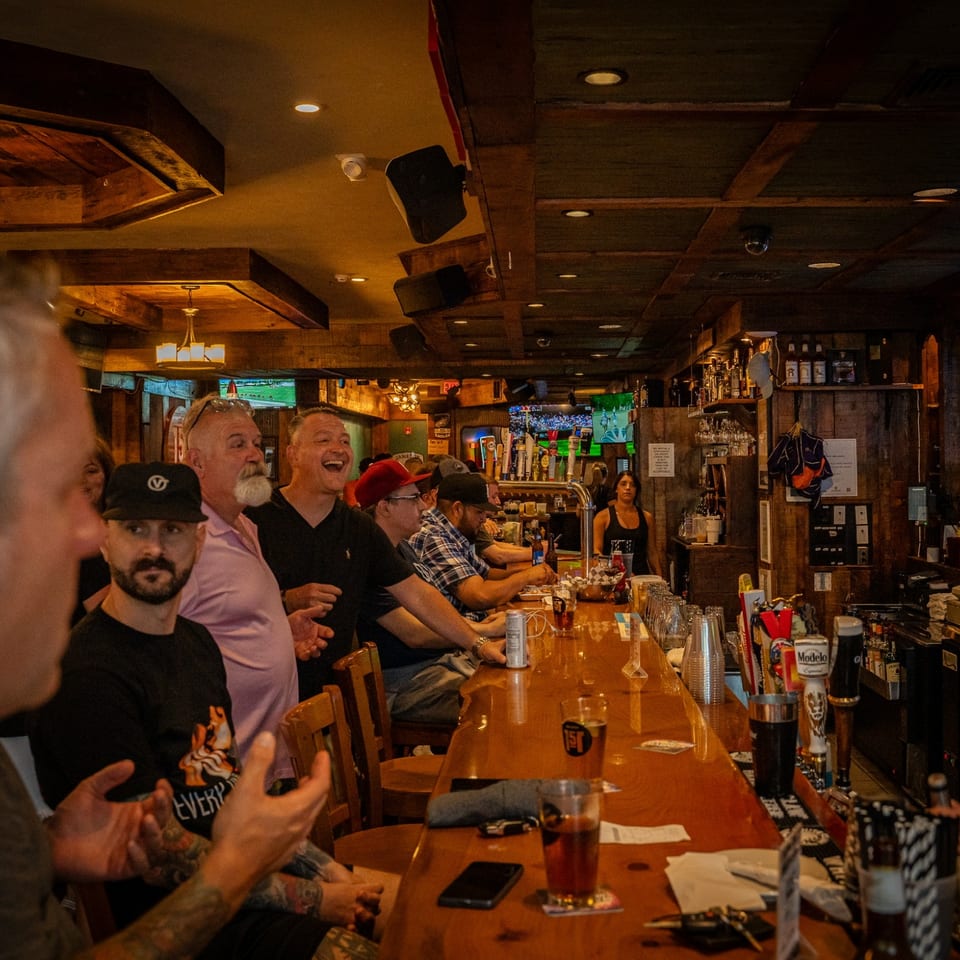 Guests gathered at the wooden bar at Saloon 151.